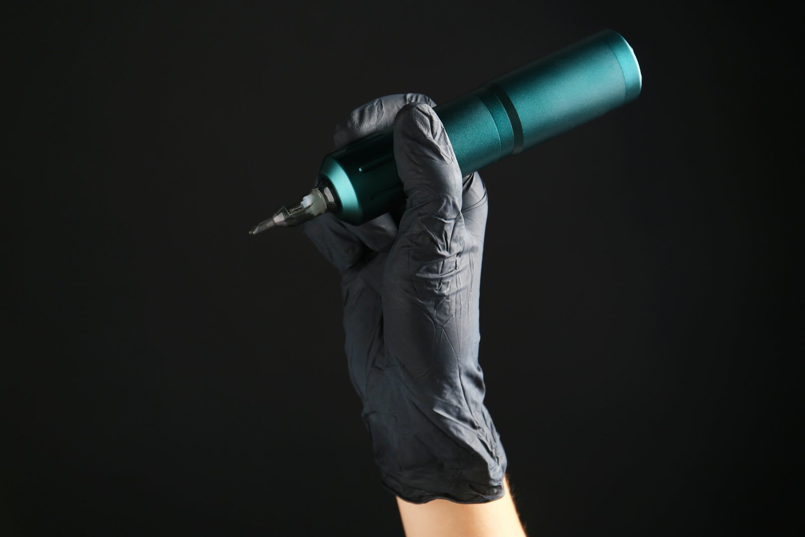 Tattoo artist holding rotary machine at Sparkle Ink Tattoos
